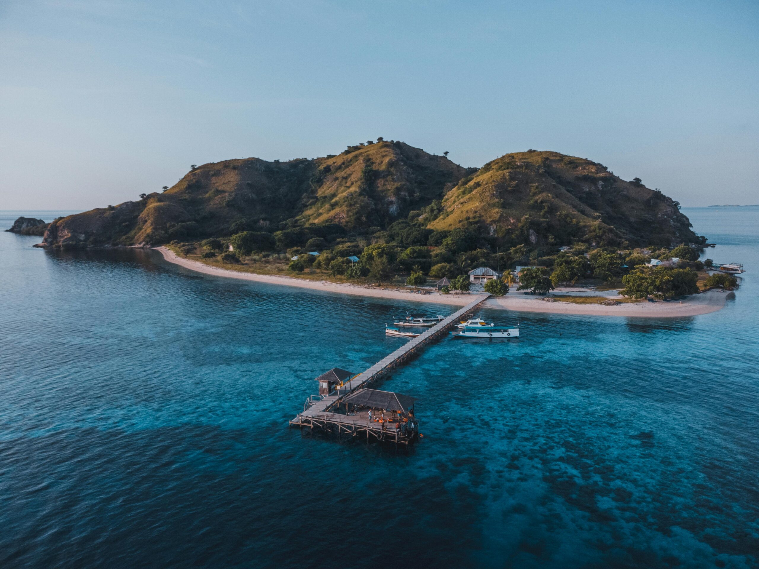 Aerial view of a scenic island with a pier in East Nusa Tenggara, Indonesia.